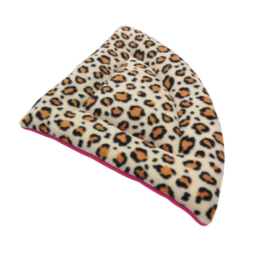 A plush pet bed with a leopard print pattern in beige, brown, and black, featuring a bright pink underside.